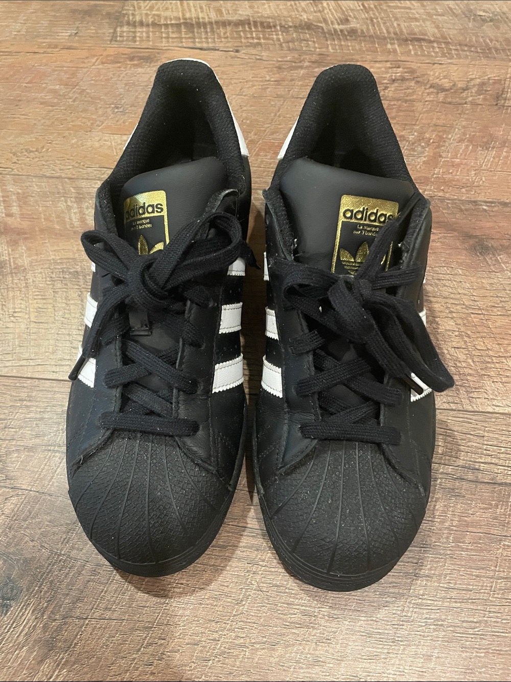 adidas Kids Black & White Shell Toe Sneakers with Gold Tongue Logo